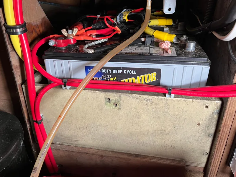 Slide: The Image of Heavy-duty deep cycle battery with red and yellow cables in a 1999 Lyle Hess Cutter. - 22