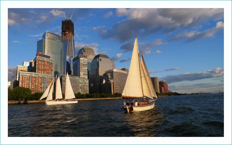 Slide: The Image of Sailboats on water with city skyline, featuring a 1999 Custom Lyle Hess Cutter. - 3