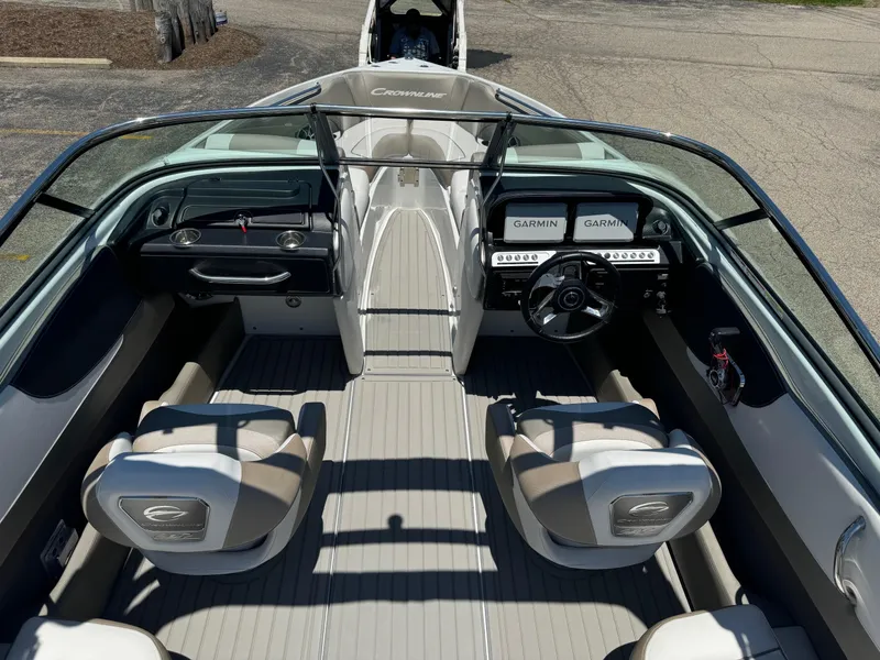 Slide: The Image of 2025 Crownline 240 SS boat interior with white and beige cushioned seating. - 11