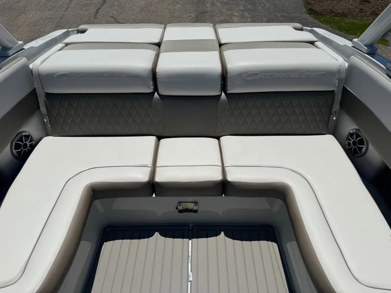 Slide: The Image of 2025 Crownline 240 SS boat propeller and stern drive in a parking lot. - 18