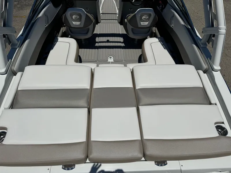 Slide: The Image of 2025 Crownline 240 SS boat interior with cushioned seating and dual captain chairs. - 2