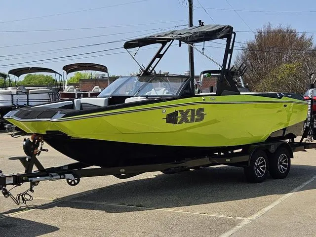 Slide: The Image of 2024 Axis Wake Research A225 boat in bright yellow on a trailer at Cherokee Motor & Marine. - 1