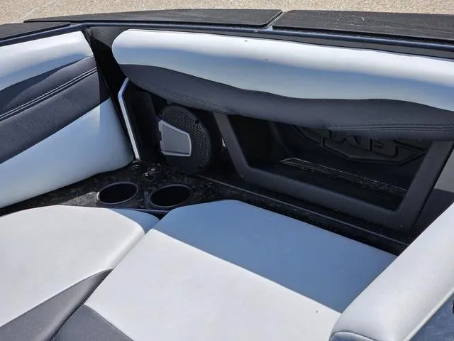 Slide: The Image of 2024 Axis Wake Research A225 boat interior with sleek seating and cup holders. - 17
