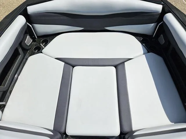 Slide: The Image of 2024 Axis Wake Research A225 boat interior with cushioned seating and cup holders. - 18