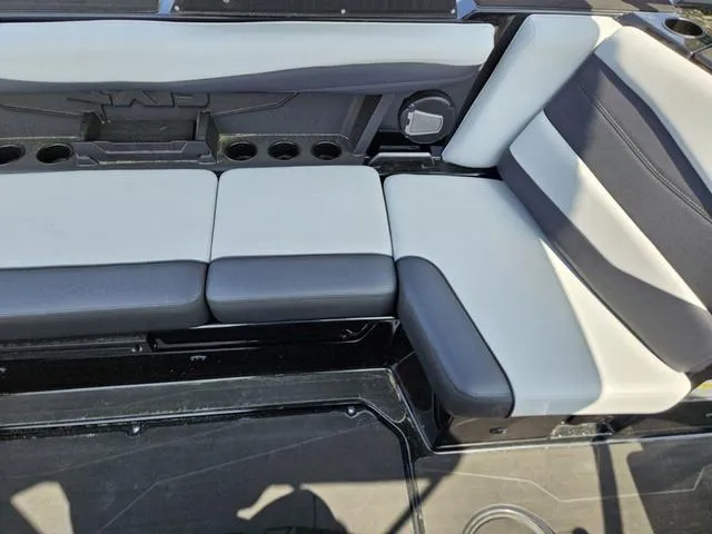 Slide: The Image of 2024 Axis Wake Research A225 boat interior seating with black and white upholstery. - 22