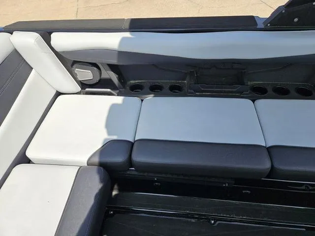Slide: The Image of 2024 Axis Wake Research A225 boat interior seating with cup holders. - 23