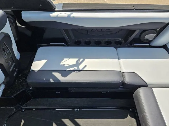 Slide: The Image of 2024 Axis Wake Research A225 boat interior seating with black and white upholstery. - 24