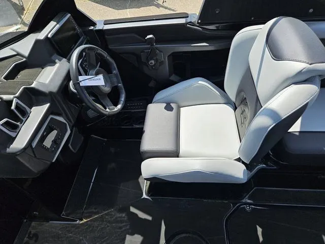 Slide: The Image of 2024 Axis Wake Research A225 boat interior with modern steering and seating. - 29