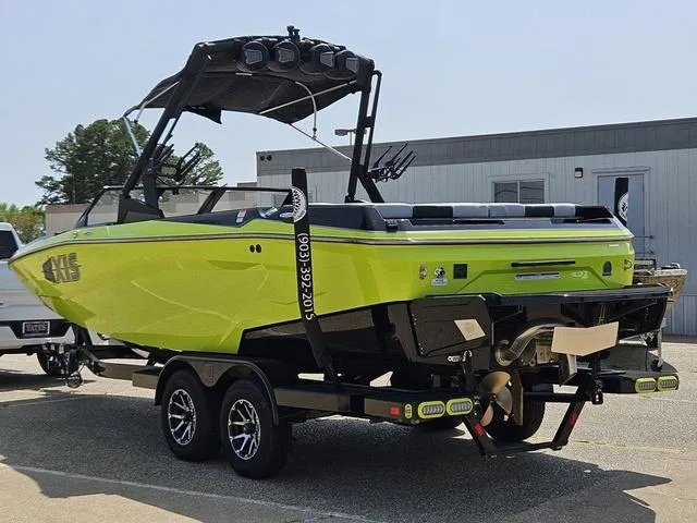 Slide: The Image of 2024 Axis Wake Research A225 boat identification plate on a vibrant green surface. - 3