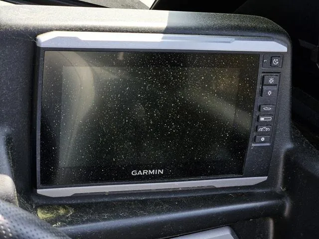 Slide: The Image of Garmin display in 2024 Axis Wake Research A225 boat cockpit, covered in dust. - 31