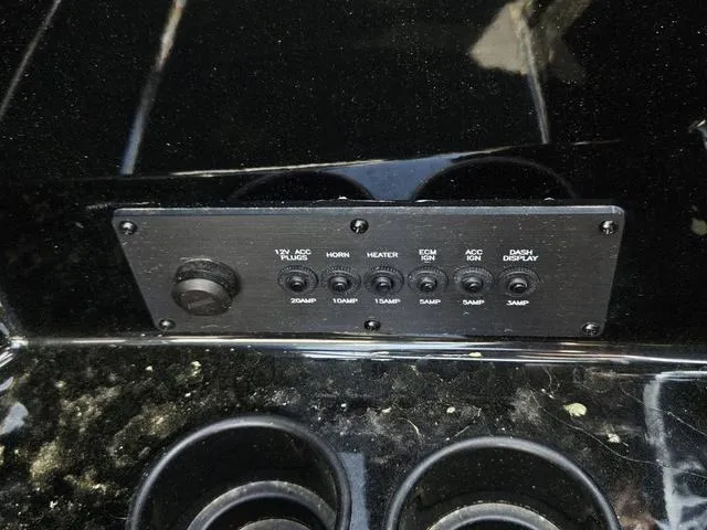 Slide: The Image of Control panel of 2024 Axis Wake Research A225 boat with various switches and cup holders. - 34