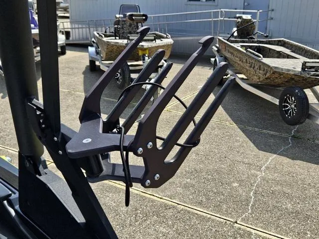 Slide: The Image of Wakeboard rack on a 2024 Axis Wake Research A225 boat, with trailers in the background. - 35