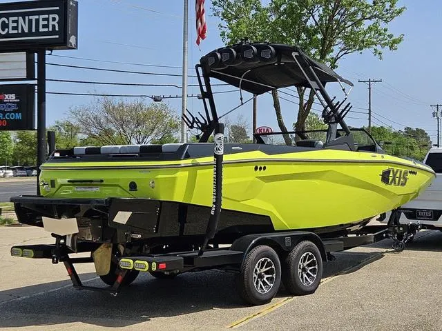 Slide: The Image of 2024 Axis Wake Research A225 boat in vibrant yellow on a trailer. - 5