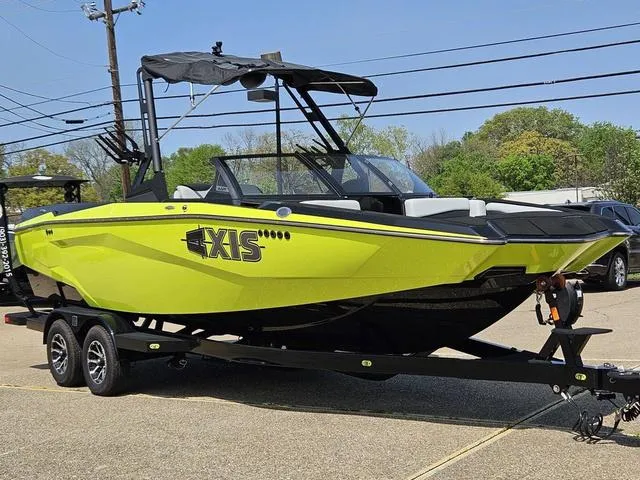 Slide: The Image of 2024 Axis Wake Research A225 boat in vibrant yellow on a trailer. - 7