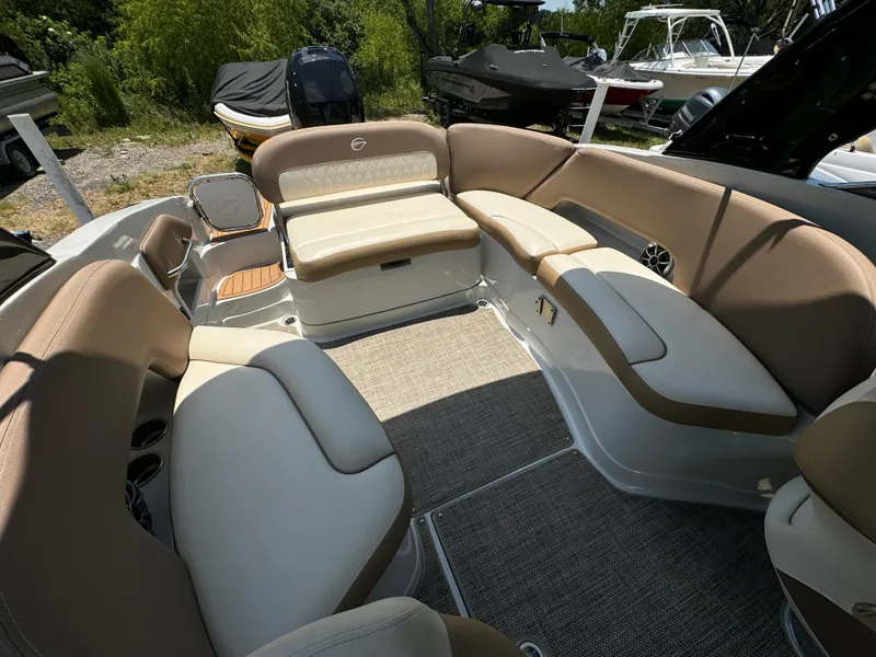 Slide: The Image of 2021 Crownline E275 XS boat interior with beige seating and carpeted floor. - 10