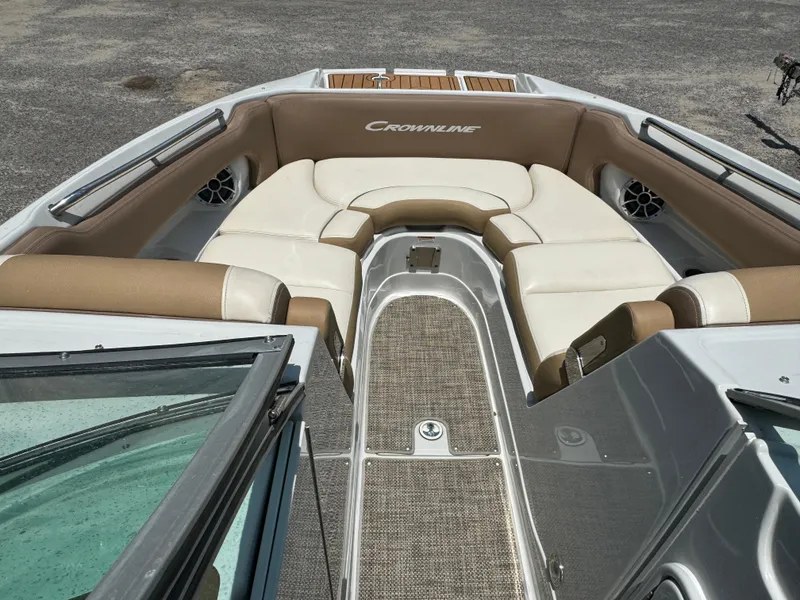 Slide: The Image of 2021 Crownline E275 XS boat interior with beige seating and carpeted flooring. - 3