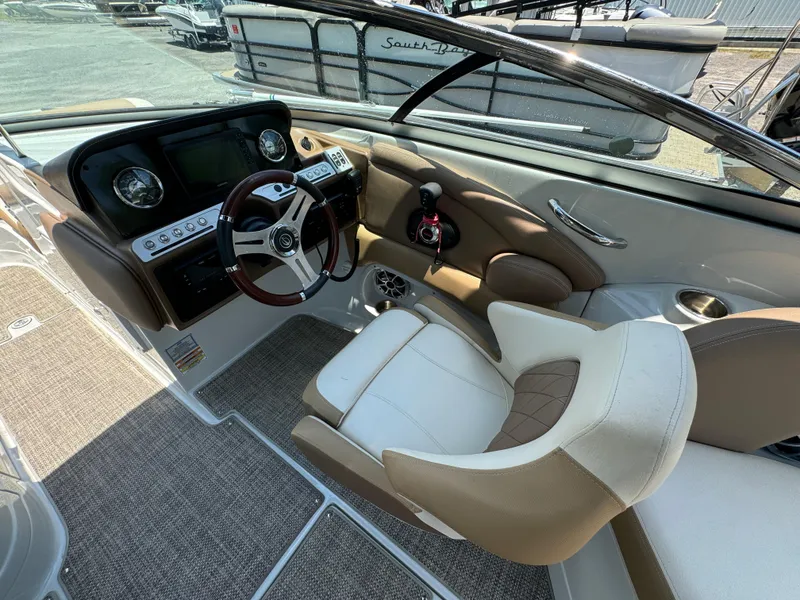 Slide: The Image of 2021 Crownline E275 XS boat cockpit with modern controls and comfortable seating. - 6