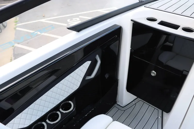 Slide: The Image of Interior of 2024 Yamaha Boats 252SD, featuring sleek design, cup holders, and quilted upholstery. - 12