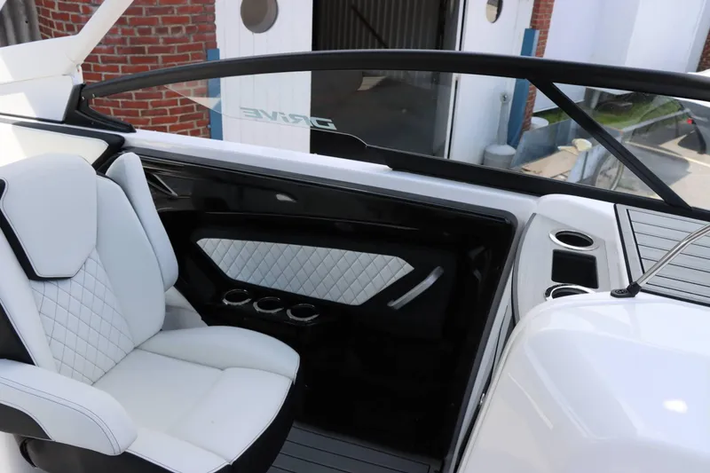 Slide: The Image of Interior of 2024 Yamaha Boats 252SD, featuring white leather seats and cup holders. - 13