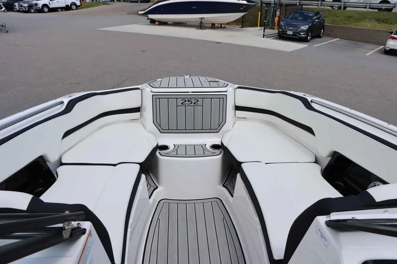 Slide: The Image of 2024 Yamaha Boats 252SD interior seating area with white and black upholstery. - 14