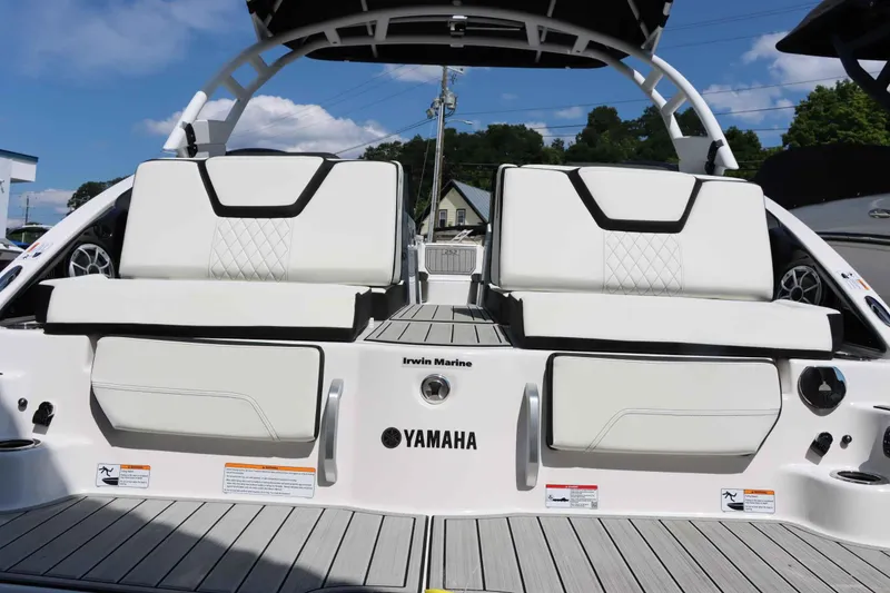 Slide: The Image of 2024 Yamaha Boats 252SD rear seating area with white upholstery and black accents. - 5