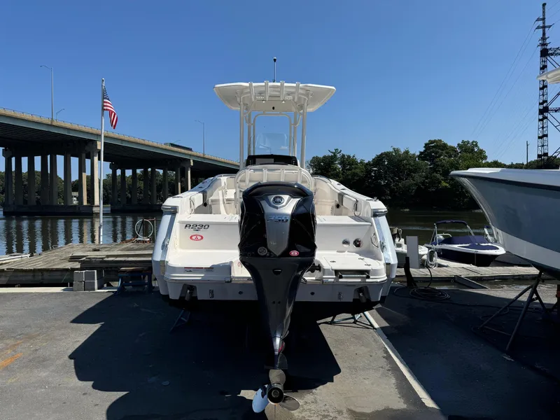Slide: The Image of 2023 Robalo R230 Center Console boat docked near a bridge. - 14