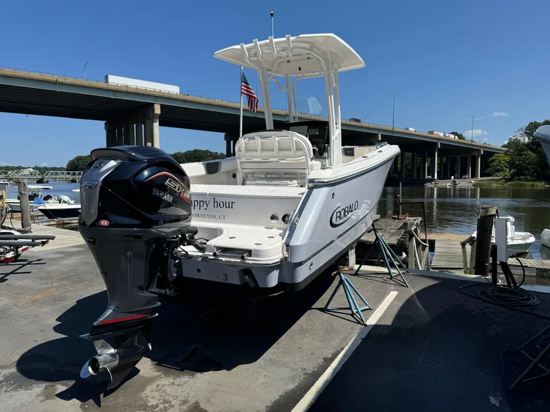 Slide: The Image of 2023 Robalo R230 Center Console boat docked near a bridge on a sunny day. - 15