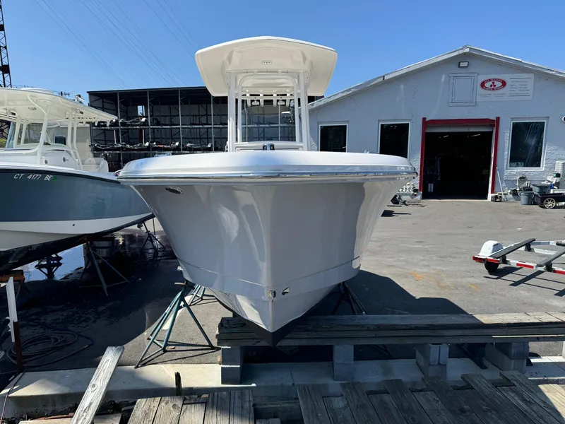 Slide: The Image of 2023 Robalo R230 Center Console boat displayed at a marina. - 17