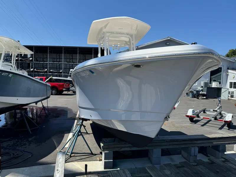Slide: The Image of 2023 Robalo R230 Center Console boat on display at a marina. - 19