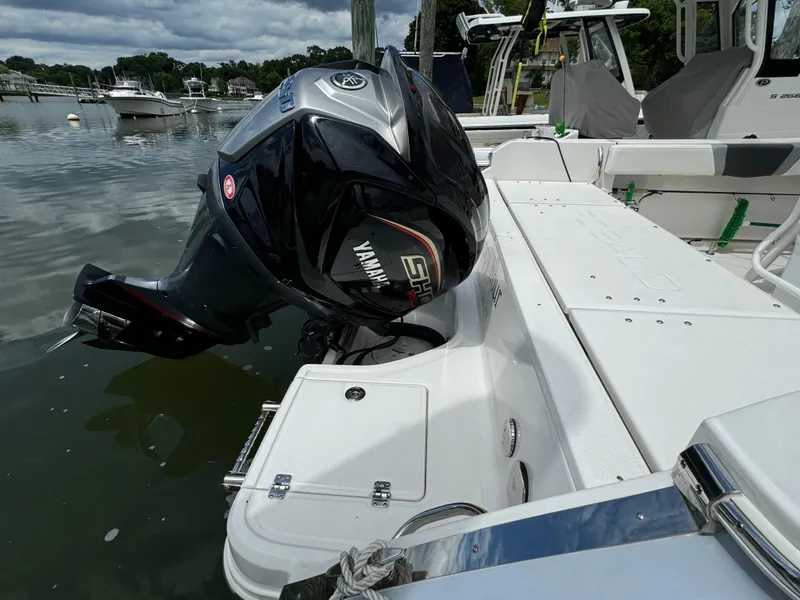 Slide: The Image of 2023 Robalo R230 Center Console with Yamaha outboard motor docked. - 2