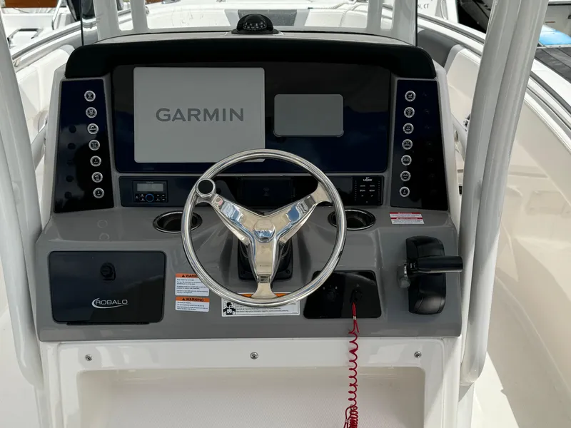 Slide: The Image of 2023 Robalo R230 Center Console boat dashboard with Garmin navigation system. - 4