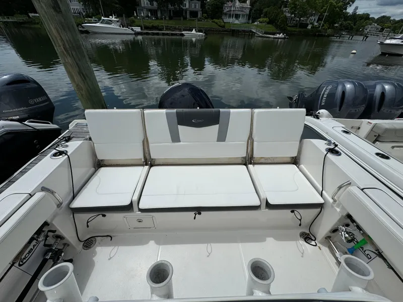 Slide: The Image of 2023 Robalo R230 Center Console boat with white seating and twin outboard motors. - 6