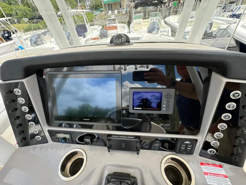 Slide: The Image of 2023 Robalo R230 Center Console dashboard with navigation screens and controls. - 7