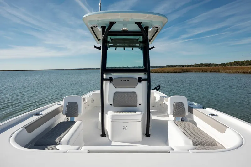 Slide: The Image of 2024 Caymas 281 HB boat on calm water with seating and console. - 11