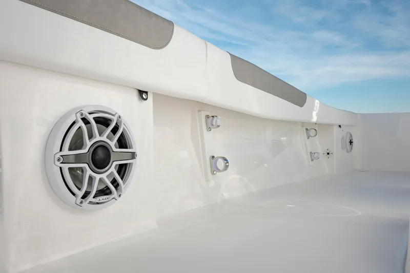 Slide: The Image of 2024 Caymas 281 HB boat interior with built-in speakers and rod holders. - 13