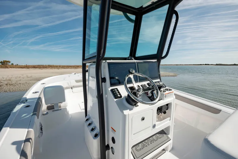 Slide: The Image of 2024 Caymas 281 HB boat interior with steering console and ocean view. - 15