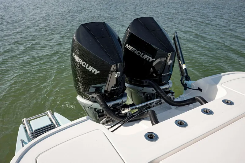 Slide: The Image of 2024 Caymas 281 HB boat with dual Mercury outboard engines on water. - 26
