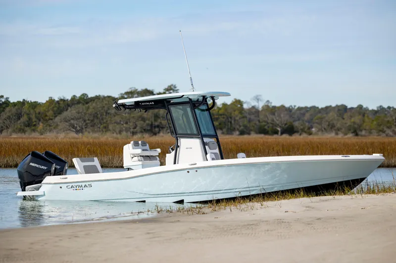Slide: The Image of 2024 Caymas 281 HB boat docked on a serene shoreline. - 36