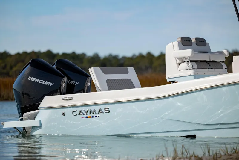 Slide: The Image of 2024 Caymas 281 HB boat with dual Mercury engines on the water. - 37