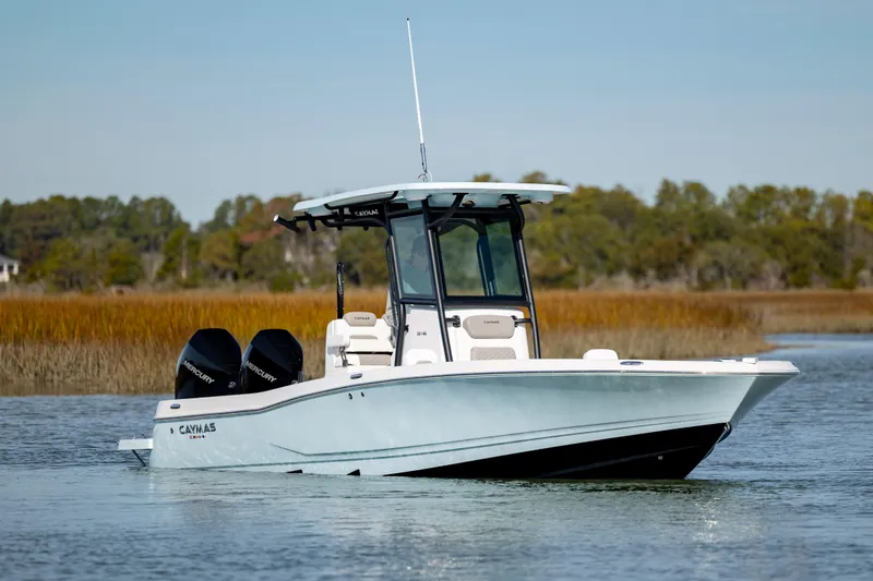 Slide: The Image of 2024 Caymas 281 HB boat on calm water with dual engines. - 4