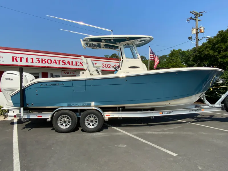 The Image of 2025 Cobia 265 CC boat on trailer at dealership. - 0