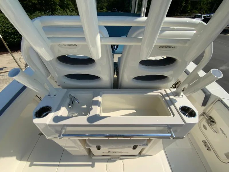 Slide: The Image of Cobia 265 CC 2025 model boat with rod holders and storage compartments. - 14