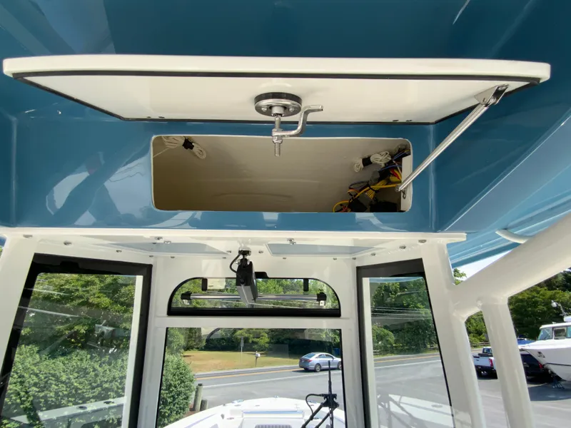 Slide: The Image of 2025 Cobia 265 CC center console storage compartment. - 15
