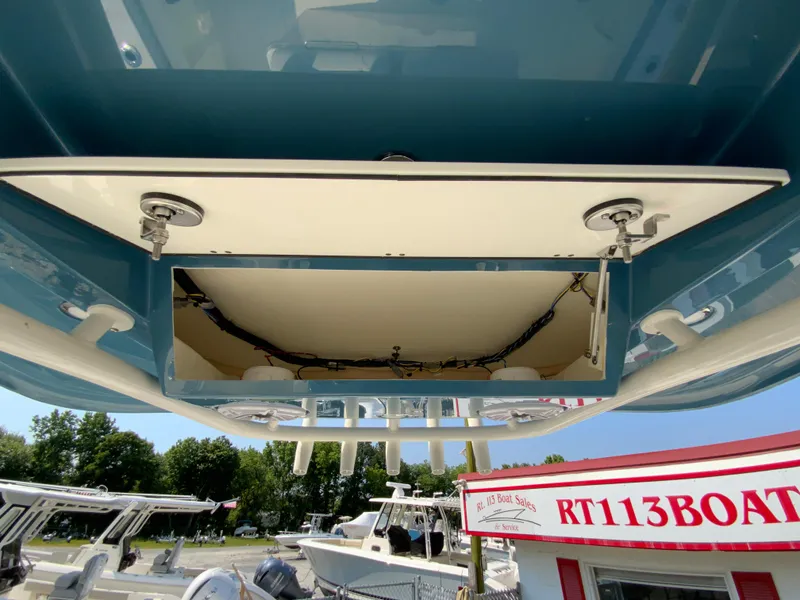Slide: The Image of 2025 Cobia 265 CC boat undercarriage view at a dealership. - 16