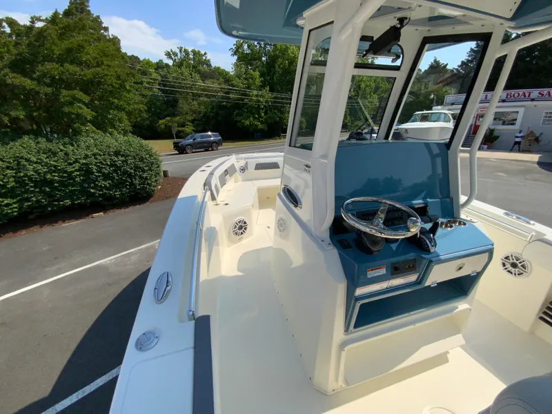 Slide: The Image of 2025 Cobia 265 CC center console boat with blue and white interior. - 31