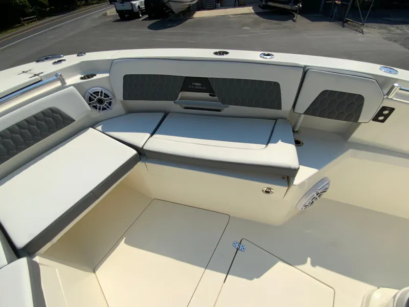 Slide: The Image of 2025 Cobia 265 CC boat interior seating area with cushioned seats and storage compartments. - 37