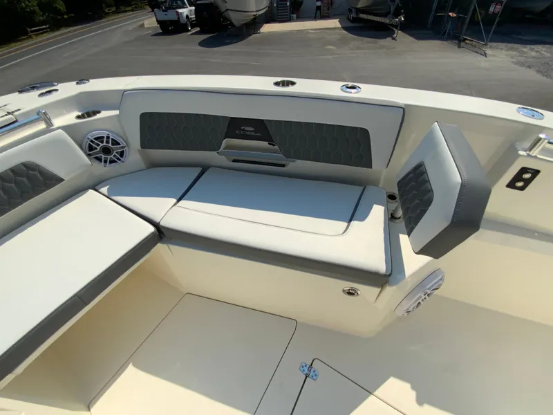 Slide: The Image of 2025 Cobia 265 CC boat interior with cushioned seating and speaker system. - 38