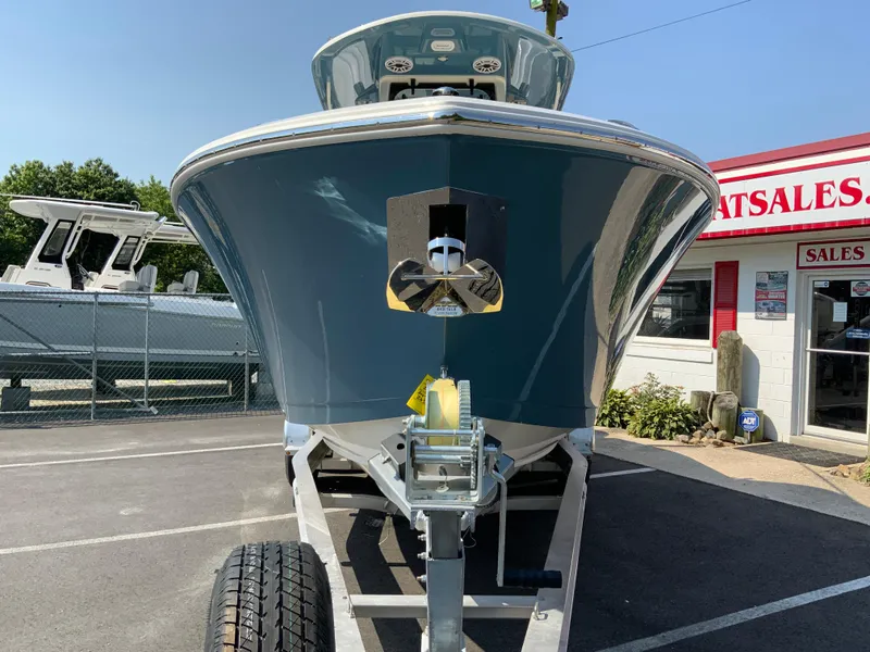 Slide: The Image of 2025 Cobia 265 CC boat on trailer at dealership. - 4