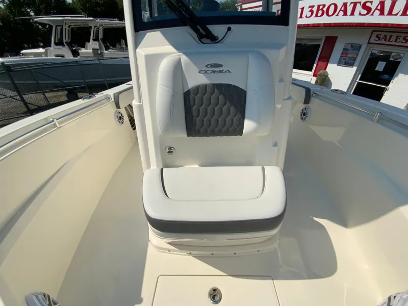 Slide: The Image of 2025 Cobia 265 CC boat interior with cushioned seating. - 42