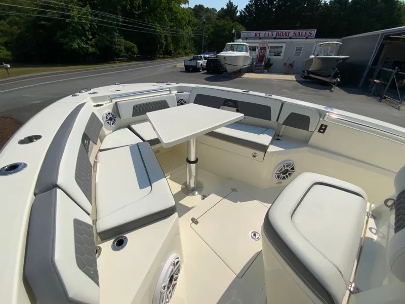 Slide: The Image of 2025 Cobia 265 CC boat with spacious seating and table. - 45